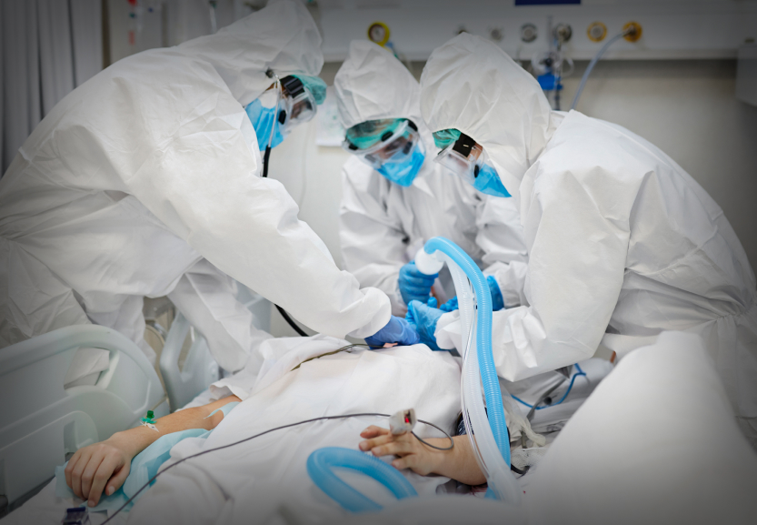 Doctors adjusting oxygen mask of young patient