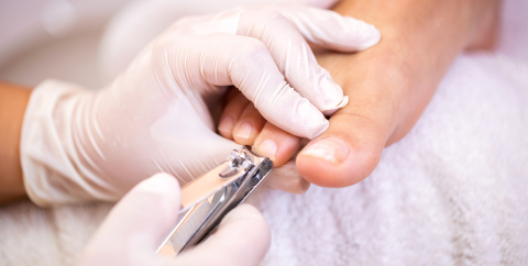a person getting their toenails clipped