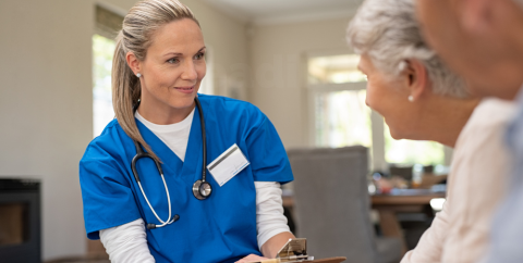 a female clinician speaks with an older couple