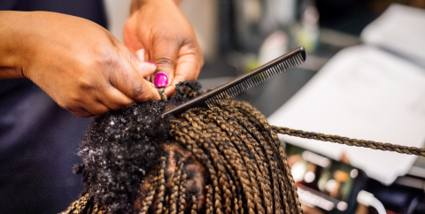 a woman braiding hair
