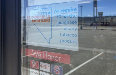 A sign on a convenience store window about being a responsible tobacco retailer