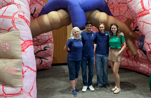 Four NCC volunteers stand in front of giant inflatable lungs