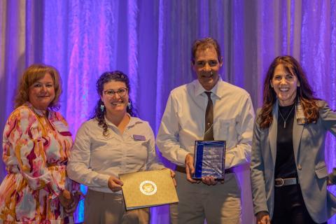 Dr. Kevin Kiene accepts his award